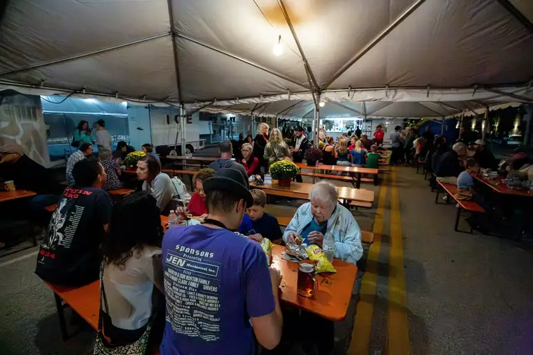 Guests eating together under the festival tent