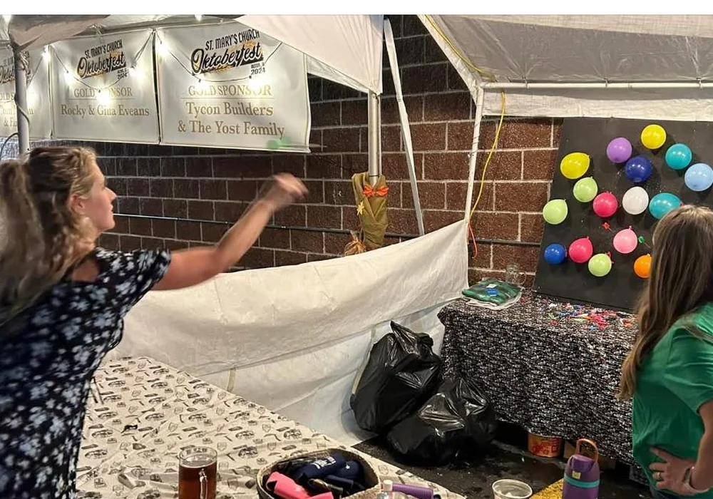 Guests playing adult darts at Oktoberfest