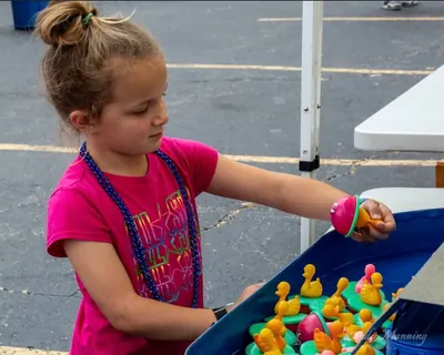 Child playing the duck pond game in the kids games area