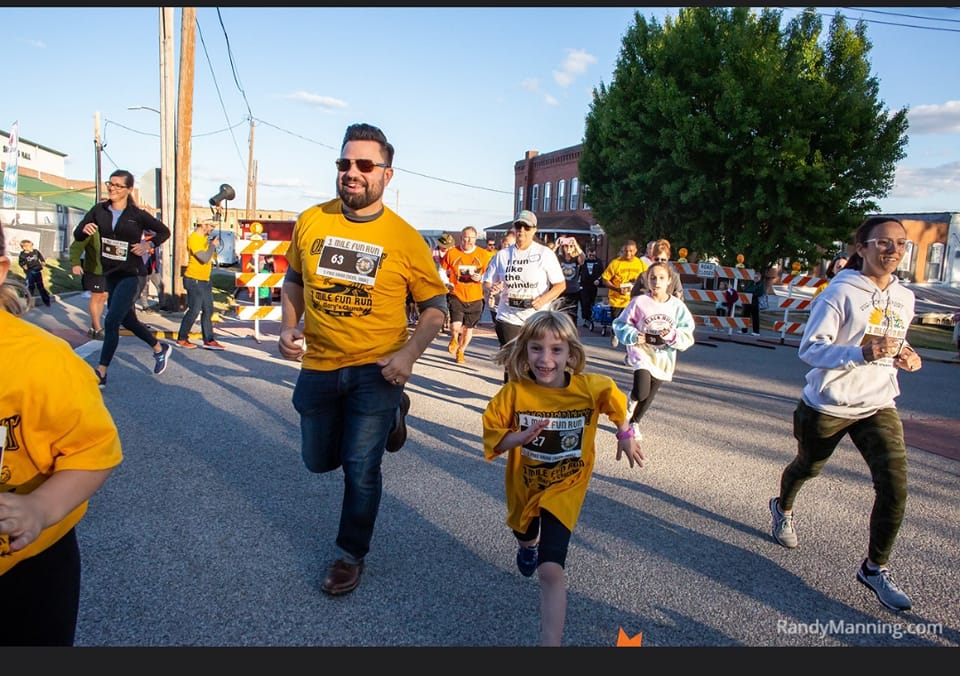 Runners smiling during a previous St. Mary’s Oktoberfest race
