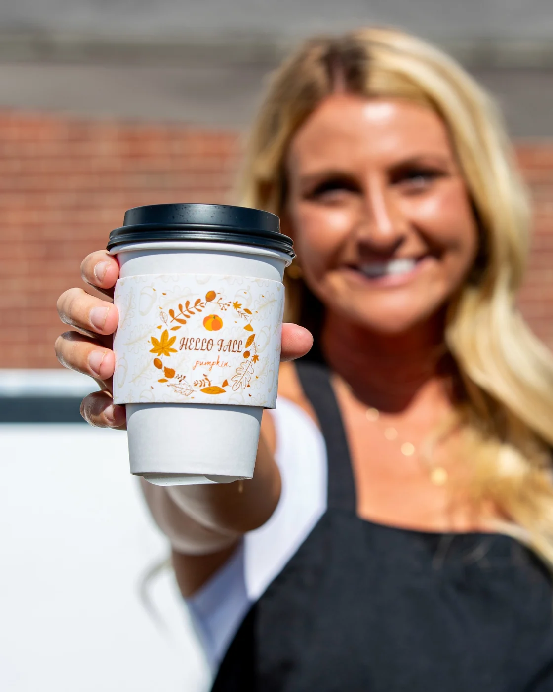 Guest holding a fall coffee drink at Oktoberfest
