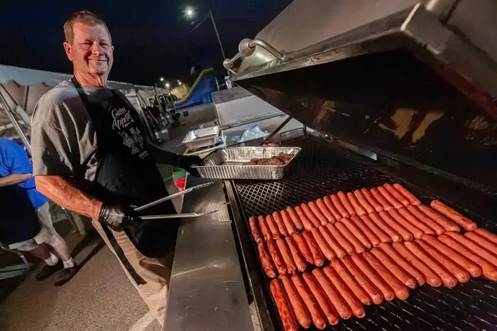 Volunteer grilling food during Oktoberfest