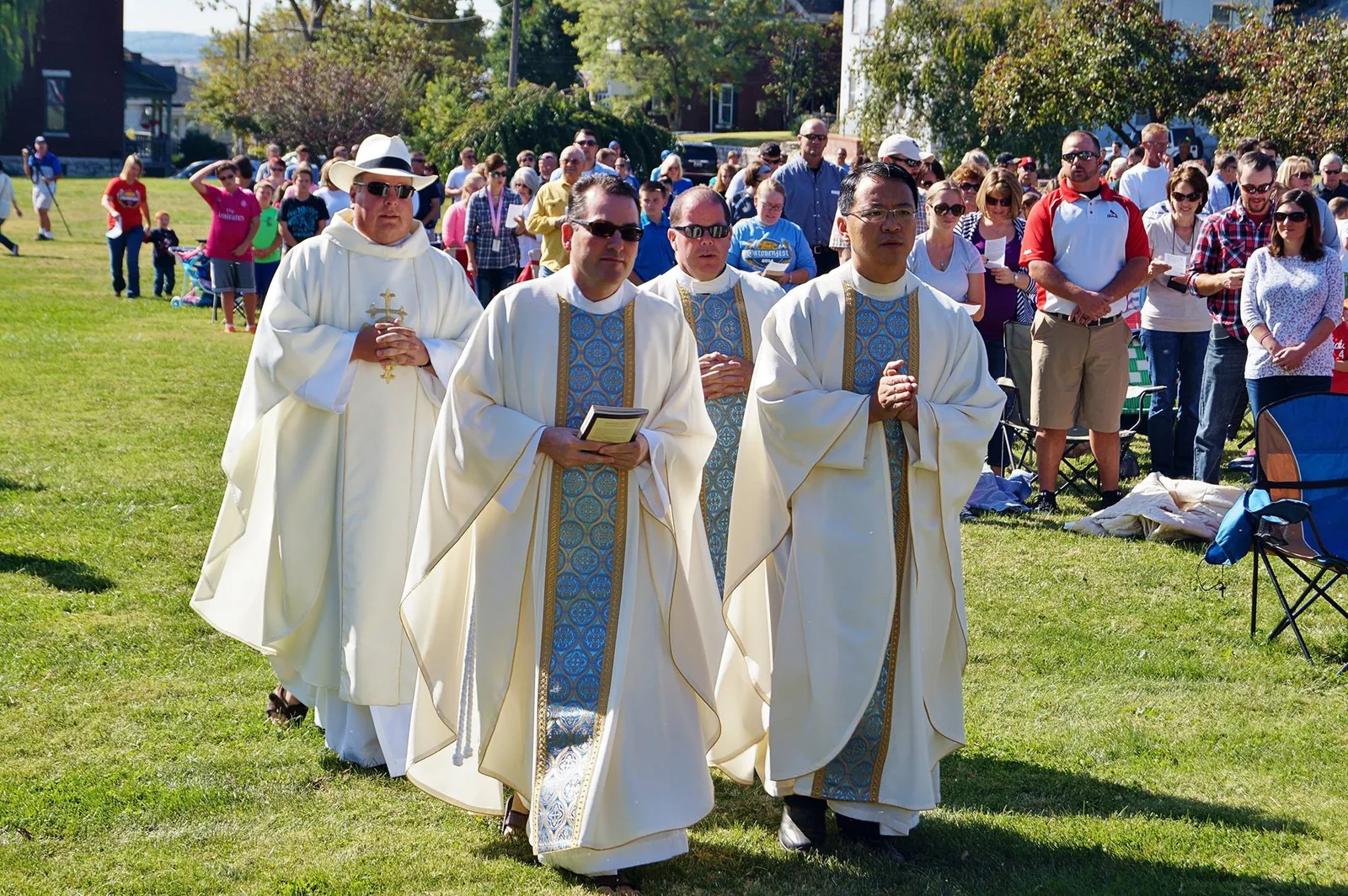 Priests processing during outdoor Mass at St. Mary’s
