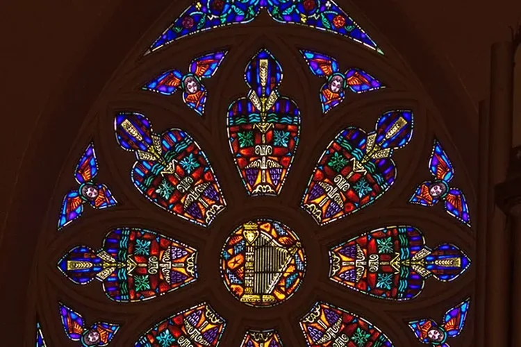 Stained glass window inside St. Mary’s Church featuring an organ motif
