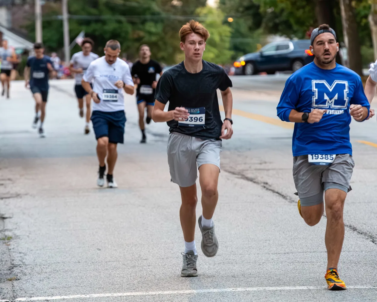Pack of runners moving along the Oktoberfest 5K route