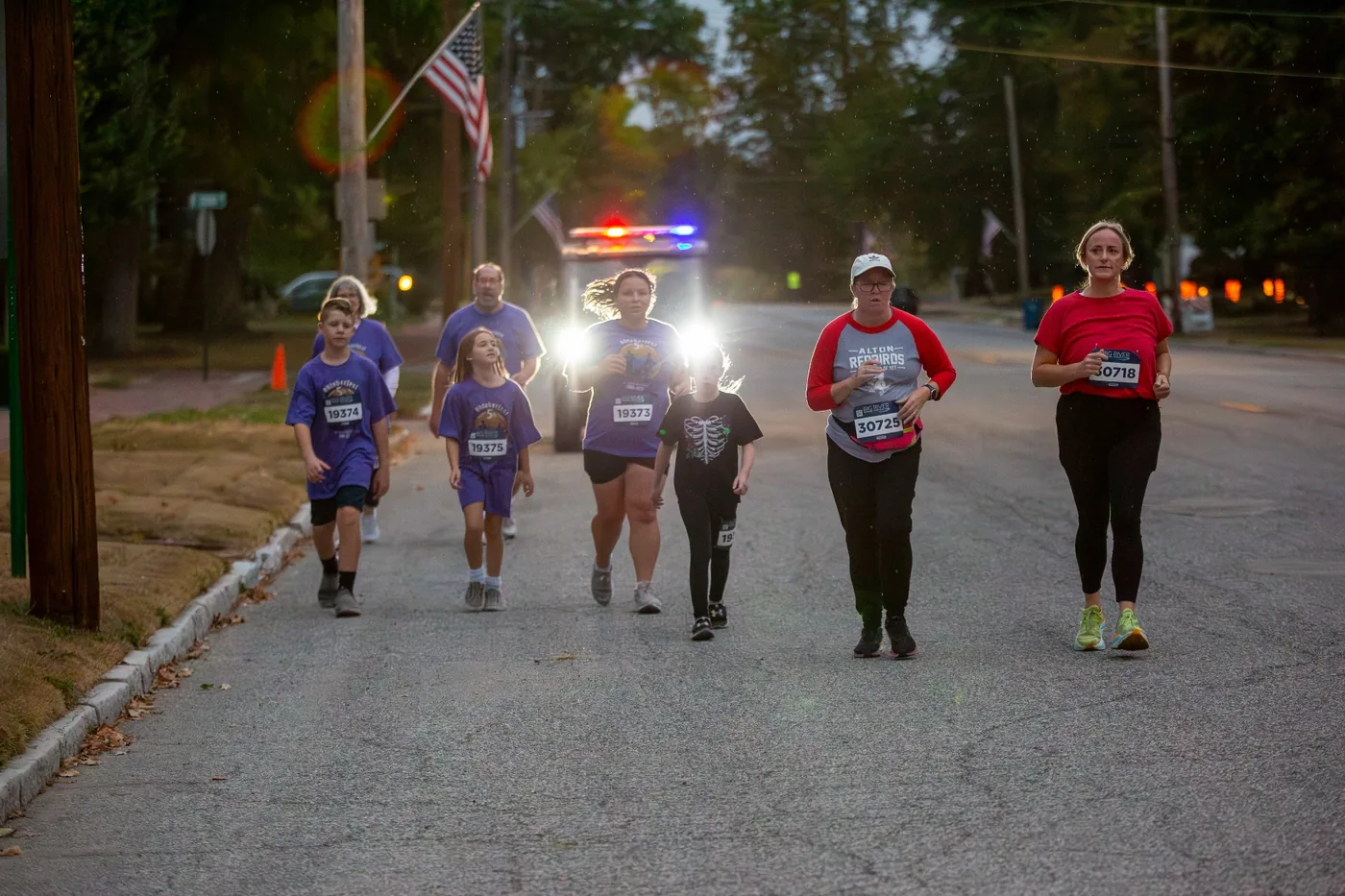 Walkers and runners on the course with safety support behind them