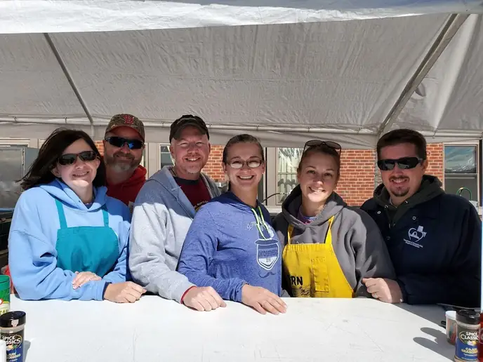Corn stand volunteers serving together at Oktoberfest