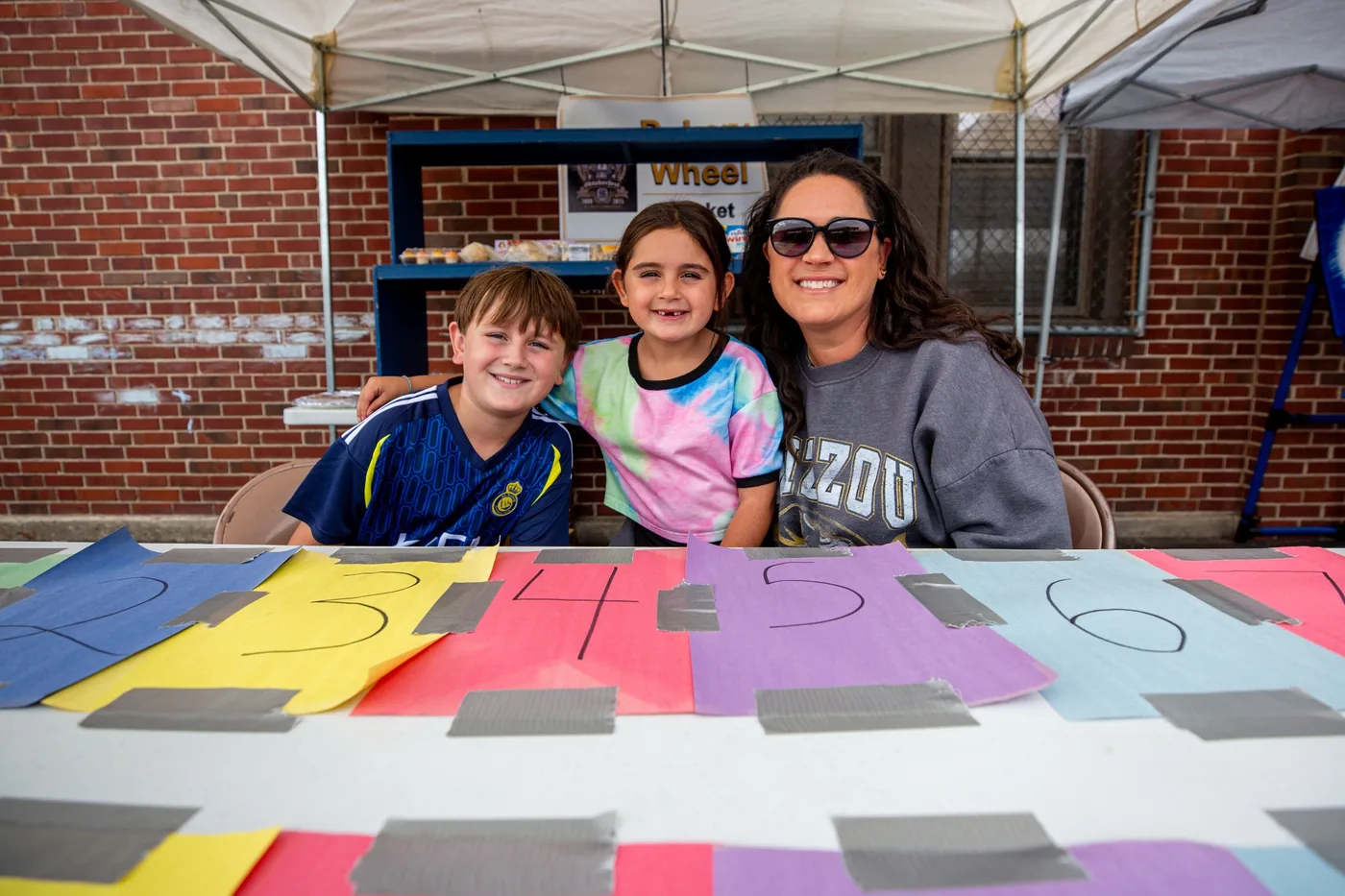 Volunteers helping at a kids games table